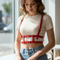 Adjustable cage chest harness by HarnessClub in red faux leather with multi-strap design.