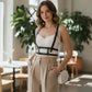 Adjustable cage chest harness with black faux leather straps over a white bralette, HarnessClub.