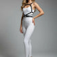 HarnessClub black vegan-leather shoulder chest harness worn over a white bodysuit