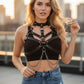 Black leather body harness with intersecting straps, metal rings, and dangling chains.