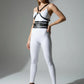 Black multi-band body harness by HarnessClub in vegan leather with chest and waist straps, worn over a white bodysuit