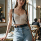 Black vegan-leather shoulder-strap waist harness by HarnessClub, shown on a model with light-blue jeans