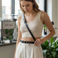 Black thin cross-body harness belt in vegan leather.
