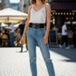 HarnessClub Black Wide O-Ring Waist Belt in vegan leather, worn over light denim jeans.
