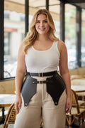 Plus-size black corset-style belt with gold buckles worn over beige pants by a smiling woman.