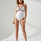 Layered Chain Bralette Harness by HarnessClub, red faux leather straps with silver chains over a white bodysuit.