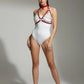 Layered Chain Bralette Harness by HarnessClub with red faux leather straps and silver rings over a white bodysuit