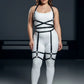 Plus-size garter harness bodysuit with black faux-leather straps on white base