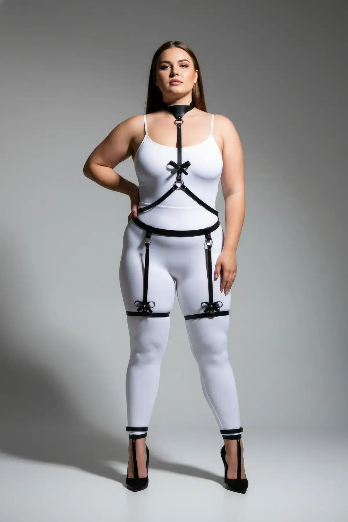 Plus Size Black Bow-Detail Faux Leather Garter Harness by HarnessClub with neck choker and leg garter straps.