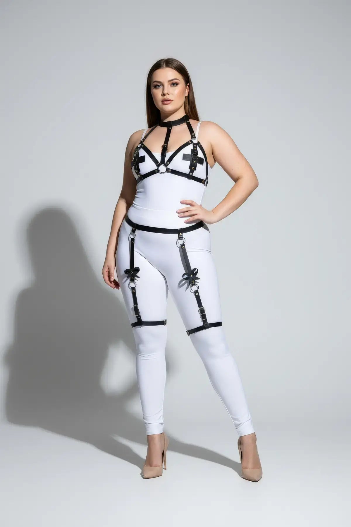 Plus size black faux-leather bustier-panel garter harness by HarnessClub, worn over a white bodysuit.