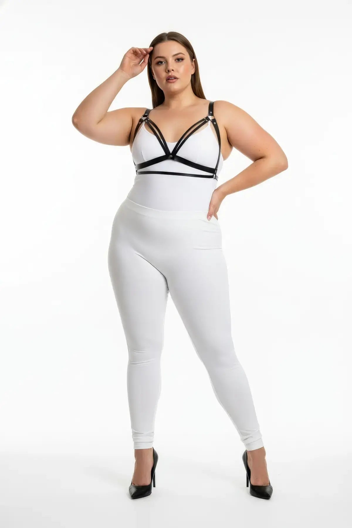 Plus-size black faux-leather bustier-style harness worn over a white bodysuit.