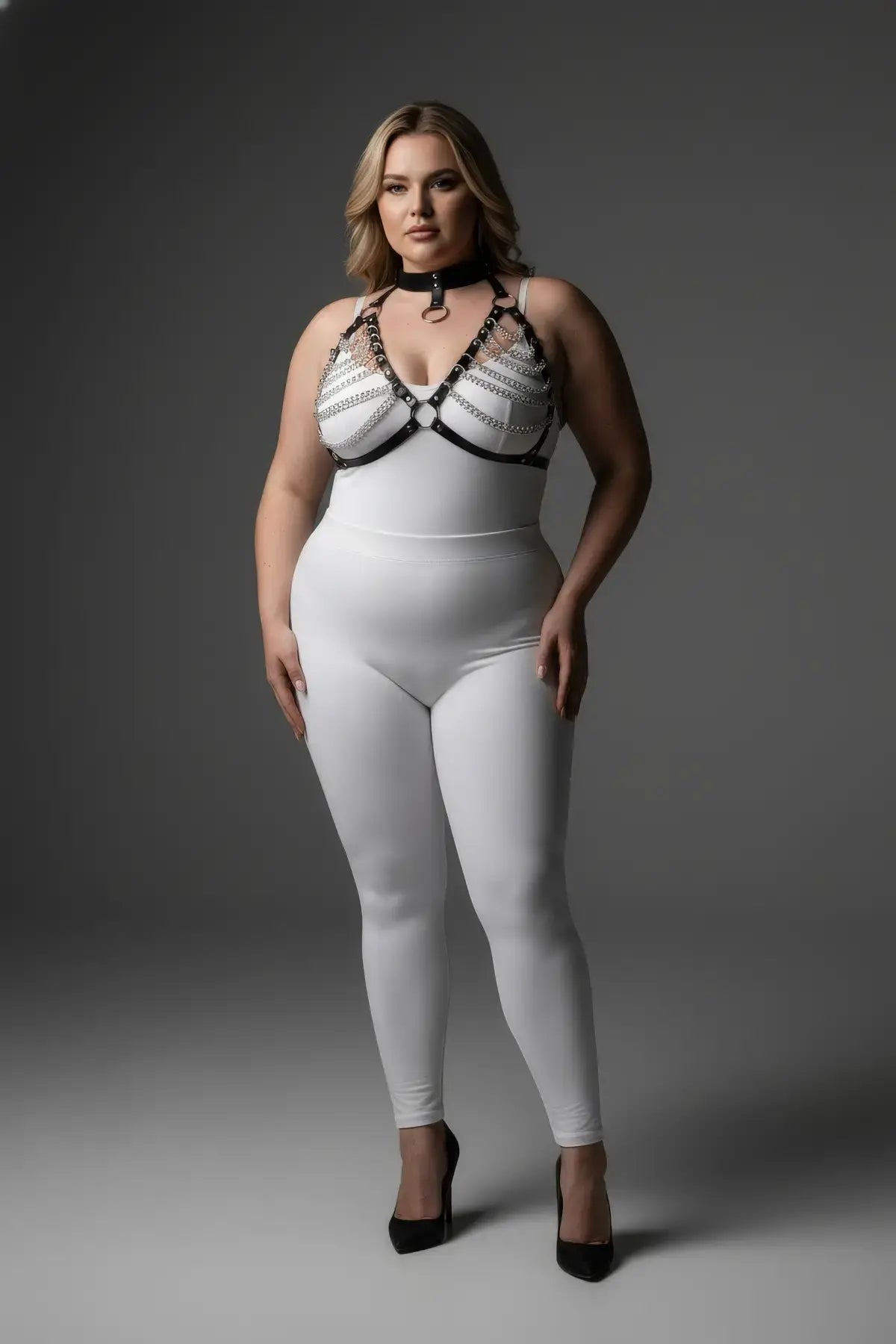 Plus-size black faux-leather chain-and-collar body harness on white bodysuit