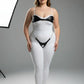 Plus-size black chain and O-ring faux leather harness set, two-piece, worn over a white bodysuit