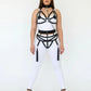 Plus-size black vegan leather body harness set with chain-back straps worn by model.