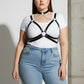 Plus-size black vegan leather chain cage chest harness worn over a white T-shirt