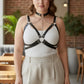 Plus size black chain cage chest harness, vegan leather with neck collar and chest rings worn over white top