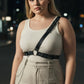 Plus-size black chain-detail body harness by HarnessClub worn over a white ribbed tank top