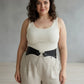 Plus-size black vegan-leather chain-detail corset harness worn at the waist.