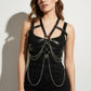 Plus size black chain-detail corset harness in vegan leather worn over a black top