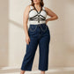 Plus-size black vegan leather chain-detail corset harness worn over a white top