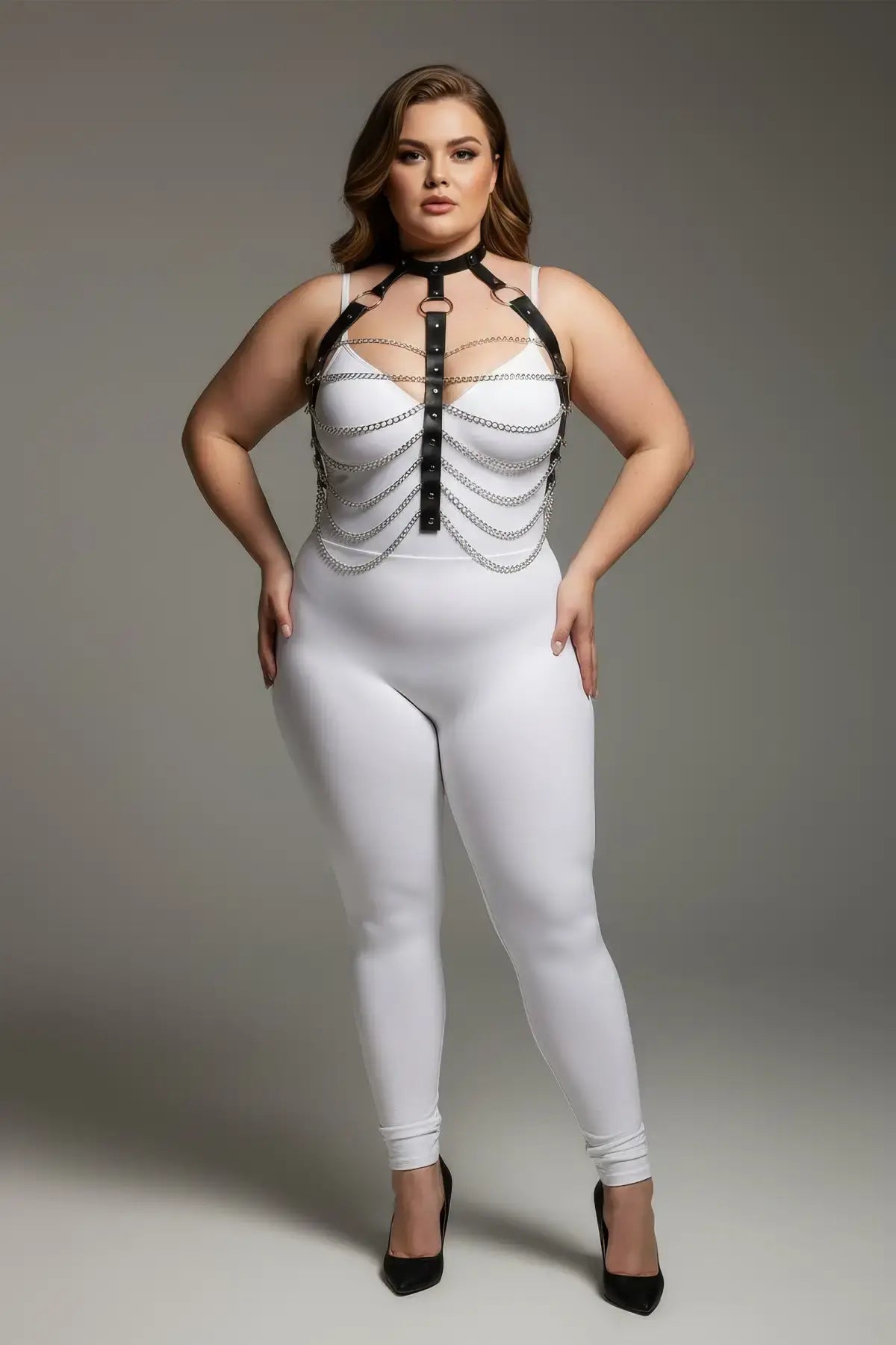 Plus-size black faux-leather chain-detail harness by HarnessClub worn over a white bodysuit