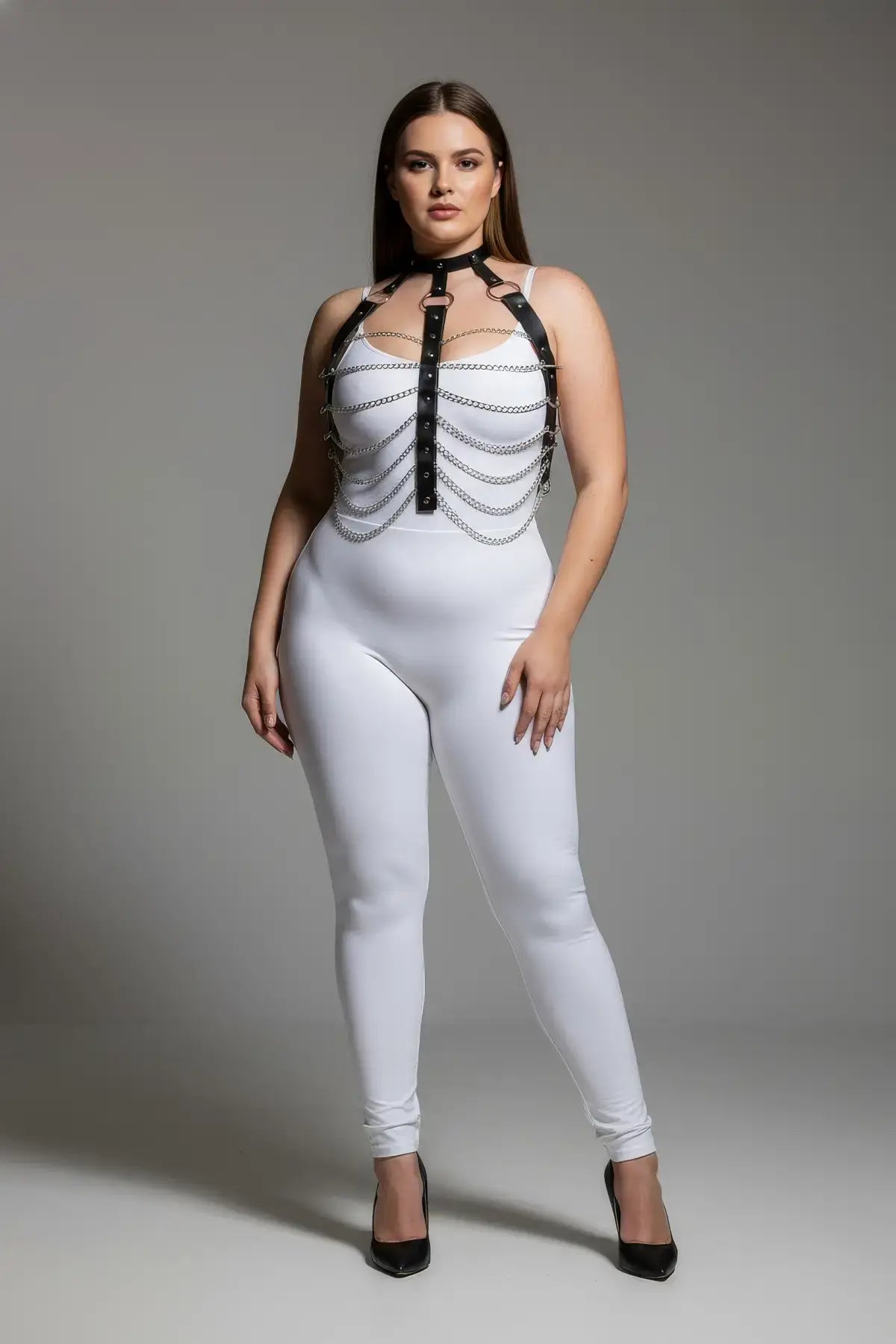Plus-size black chain-detail faux-leather harness worn over a white bodysuit
