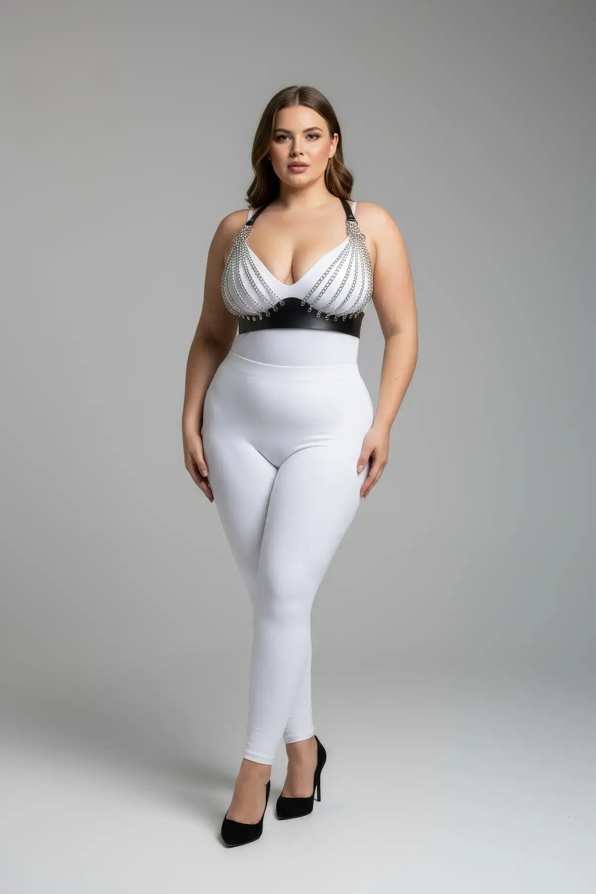 Plus size harness set with black chain-detail faux leather worn over a white bodysuit