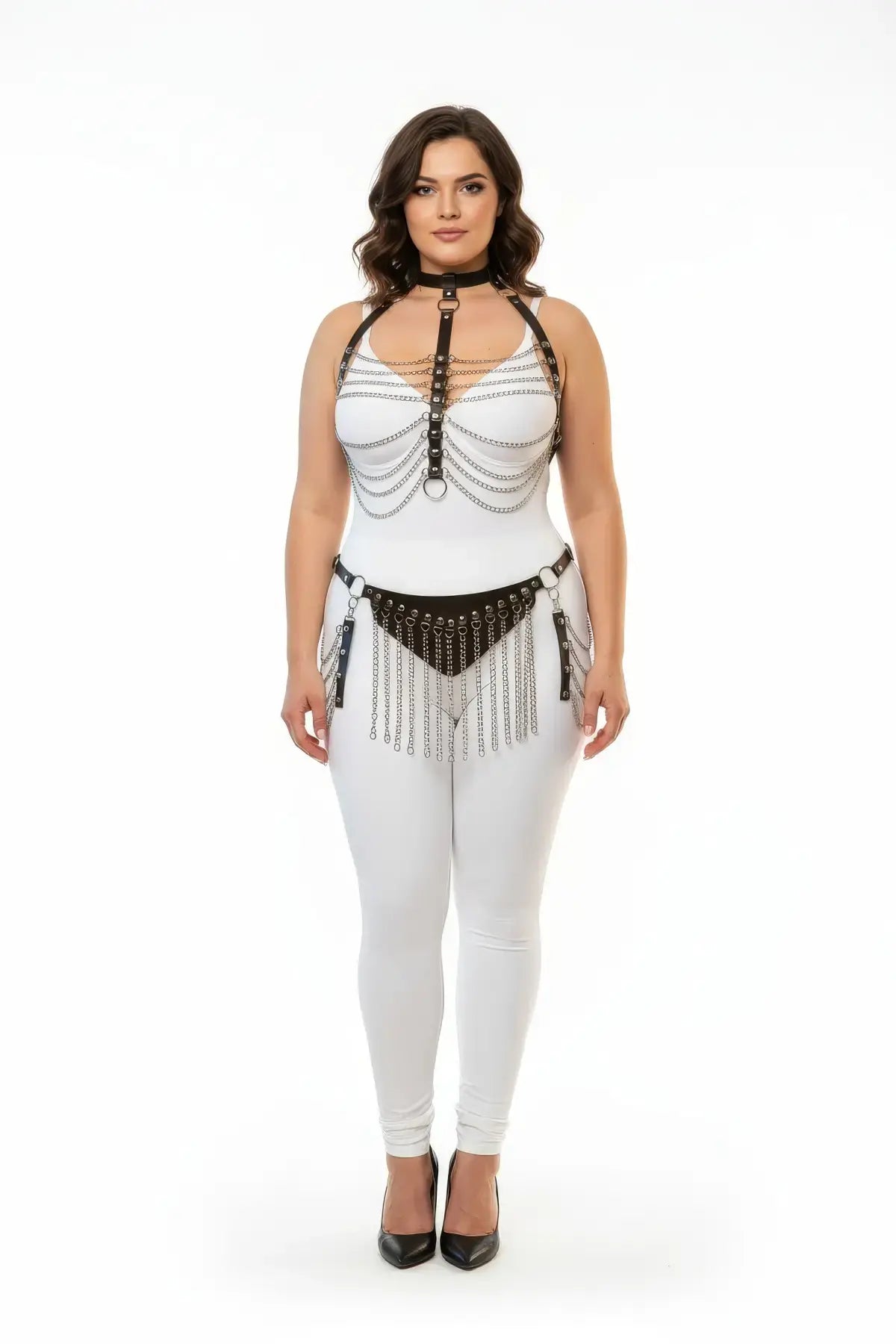 Plus-size black vegan leather chain-drape and fringe harness set on model wearing a white bodysuit.
