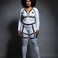 Plus-size black chain-drape thigh-cage harness set on model over white bodysuit; vegan leather with silver chains.