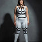 Plus-size black vegan-leather full-body harness with chain-draped lower half by HarnessClub over white bodysuit.