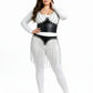 Plus-size 2-piece black vegan-leather bralette and fringe skirt set by HarnessClub with silver chain detailing