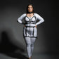 Plus size black chain-link garter harness set with vegan leather straps worn over a white bodysuit