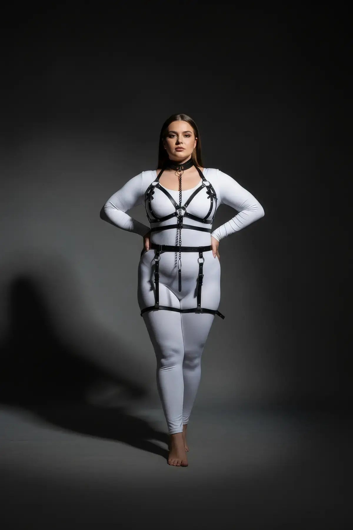 Plus size black chain-link garter harness set with vegan leather straps worn over a white bodysuit
