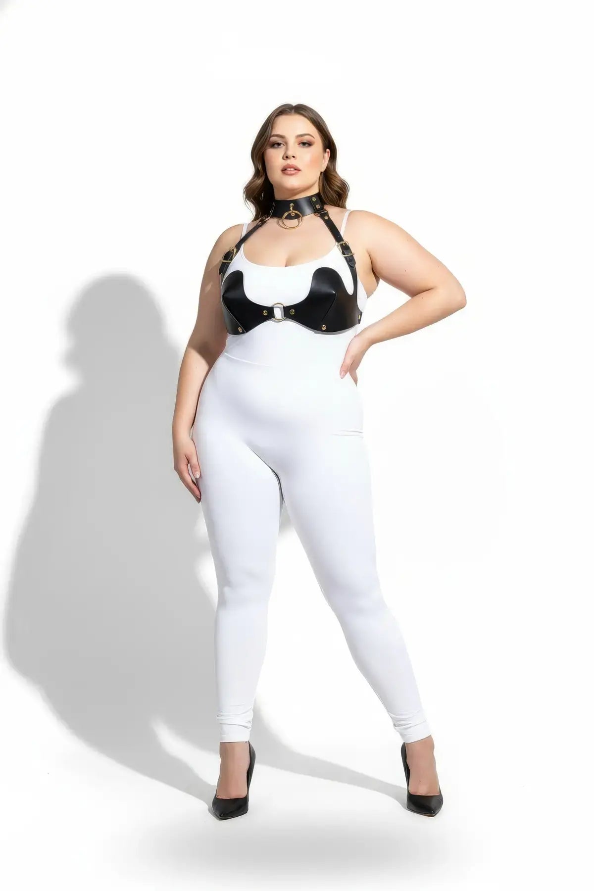 Plus-size black faux-leather chest harness and choker two-piece set by HarnessClub on model wearing white bodysuit.