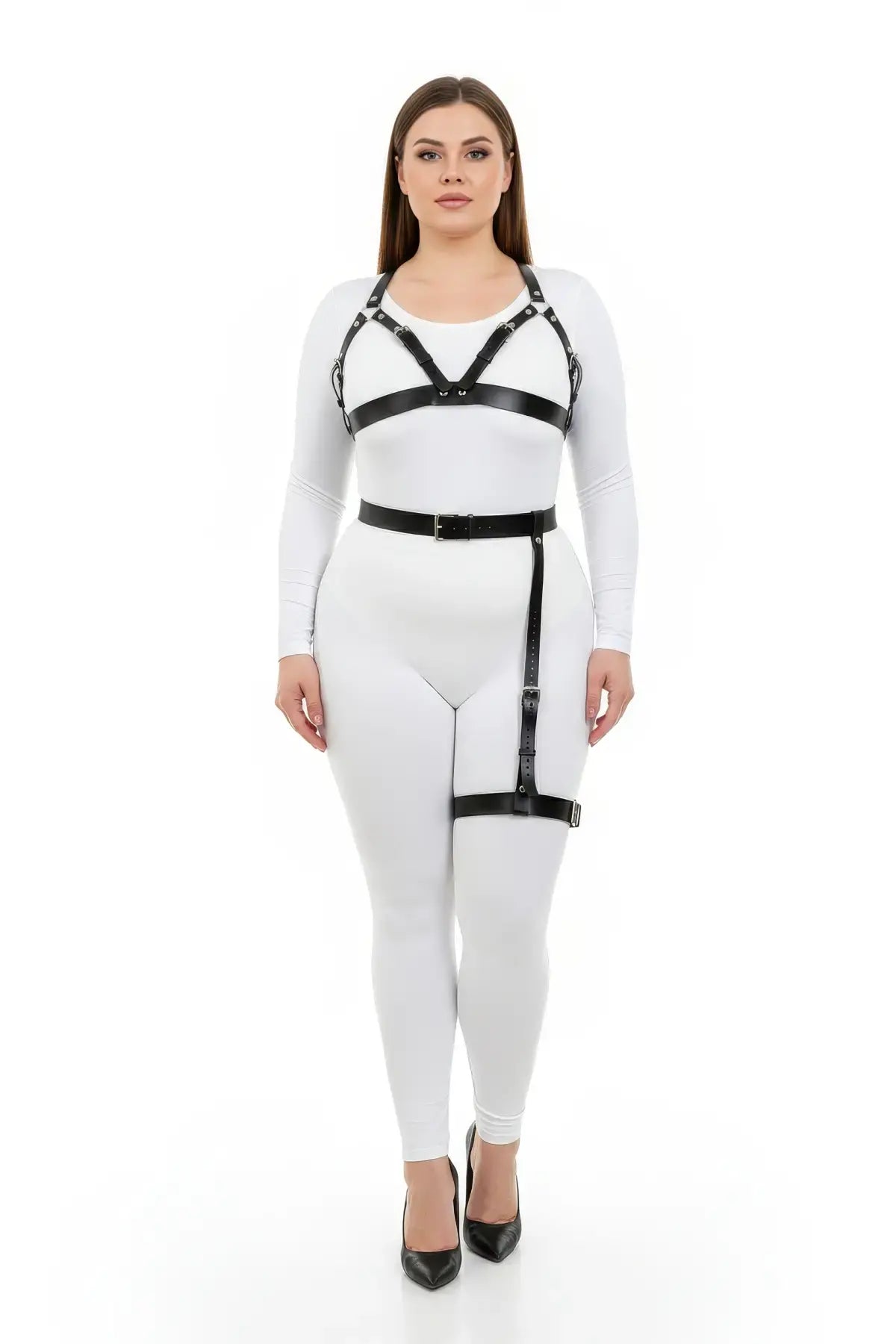 Plus size black vegan-leather chest harness and single-leg garter set worn over a white bodysuit