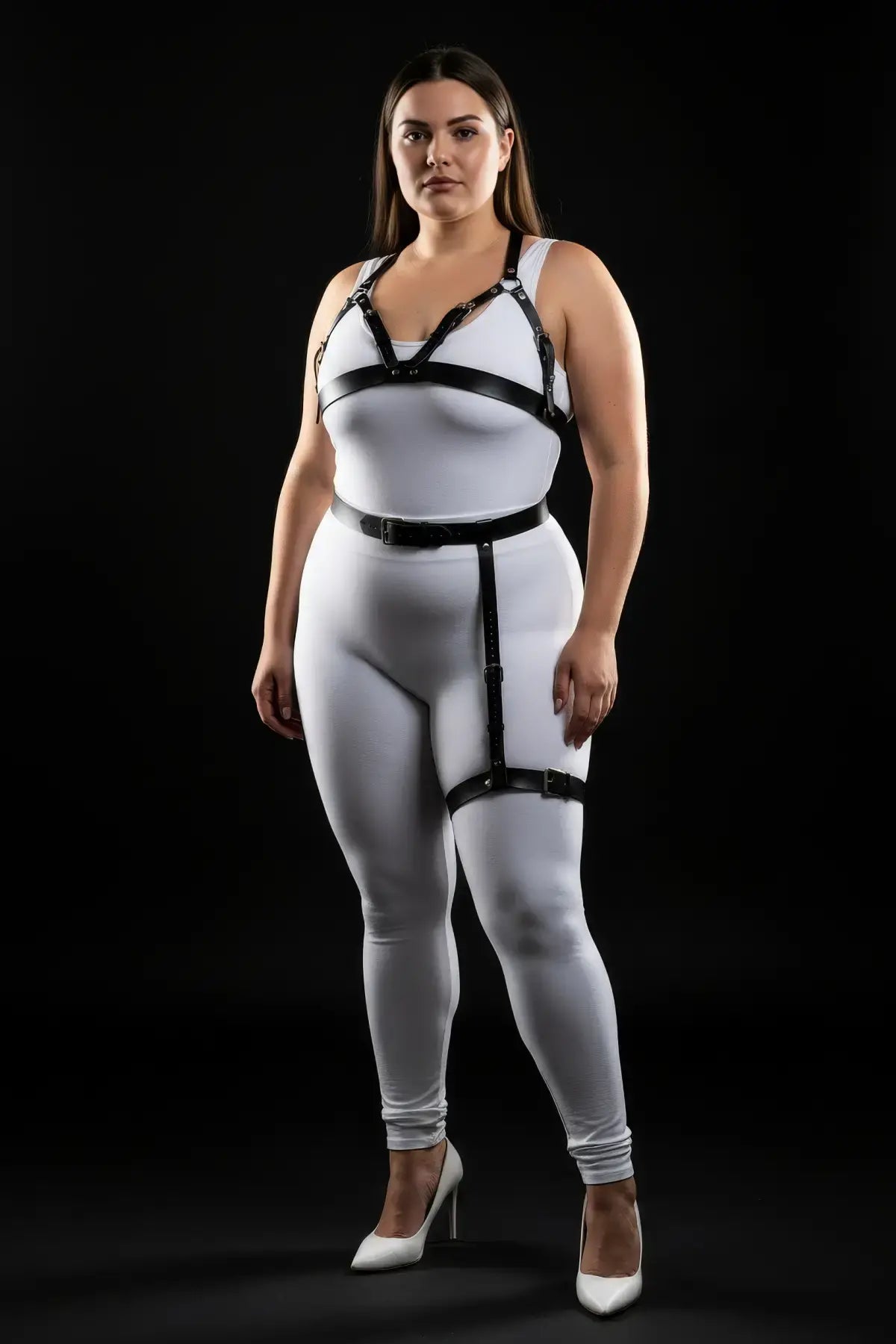 Plus-size black vegan-leather chest harness with single-leg garter set by HarnessClub, worn over white bodysuit