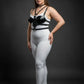 Plus-size black faux-leather choker and chest harness set worn with a white bodysuit