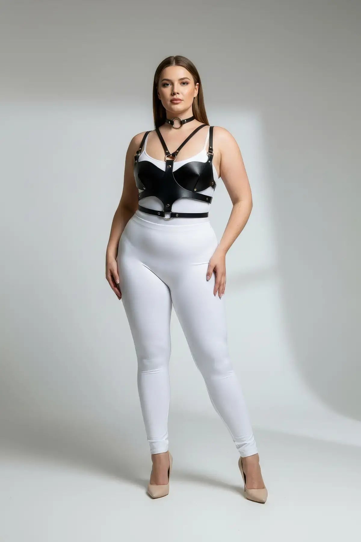 Plus-size black faux-leather choker and chest harness set with metal rings on model