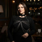 Plus-size black choker chain bib harness worn by model, vegan leather with metal chains across chest.