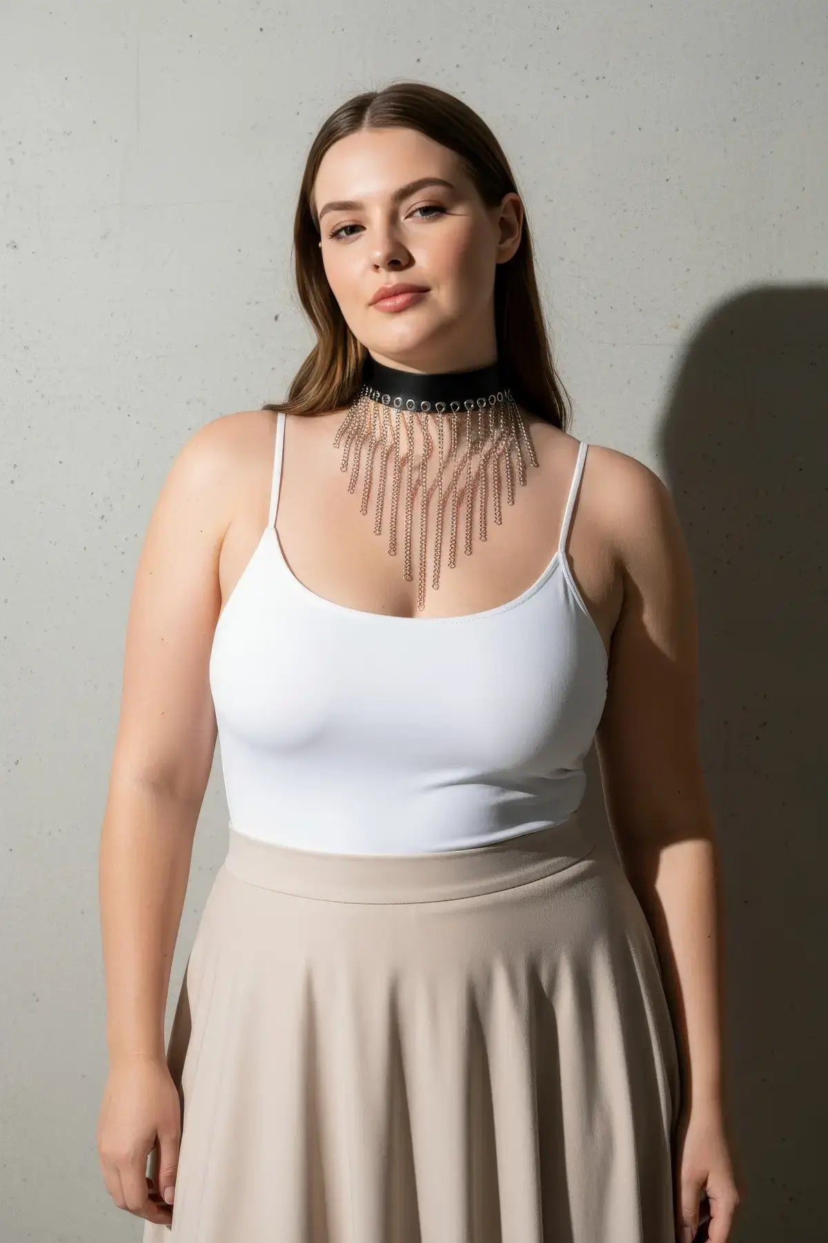 Plus-size black vegan leather choker with silver chain fringe bib worn by model