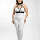 Plus-size black faux-leather harness set with collar, chest straps, and waist belt over white bodysuit