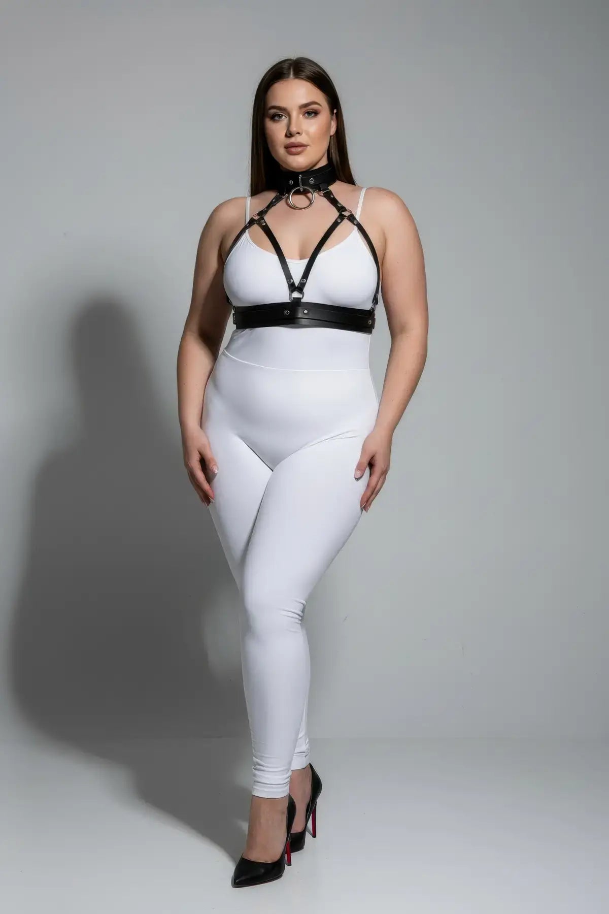 Plus-size black collar-detail faux leather harness set worn over a white bodysuit, body accessory.