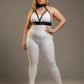 Plus-size black faux-leather harness with collar detail worn over a white bodysuit.