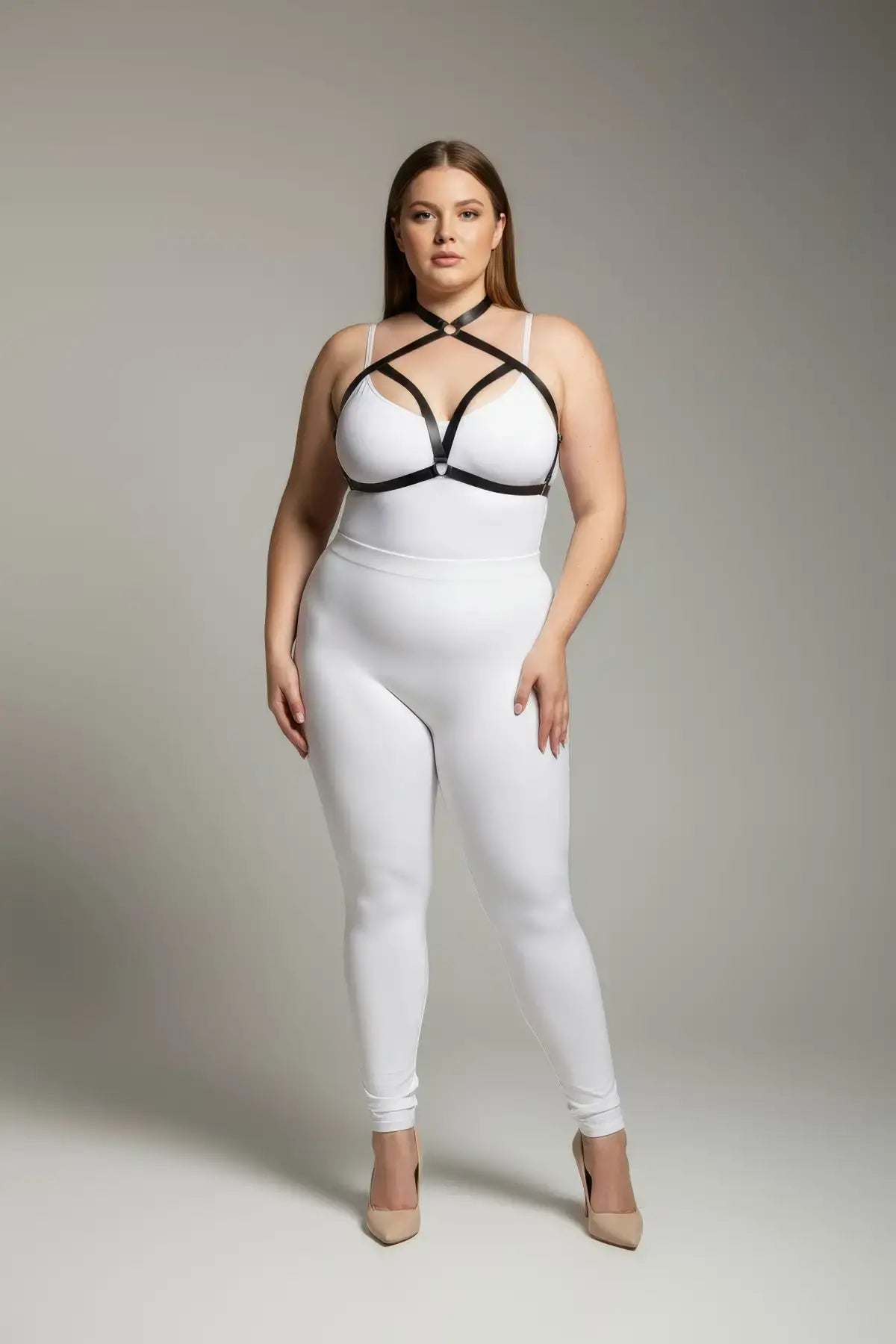 Plus-size black cross-strap elastic chest harness with choker worn over a white bodysuit.