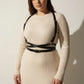 HarnessClub Plus Size Black Diagonal Cross-Strap Body Harness, vegan leather, worn over beige ribbed dress.