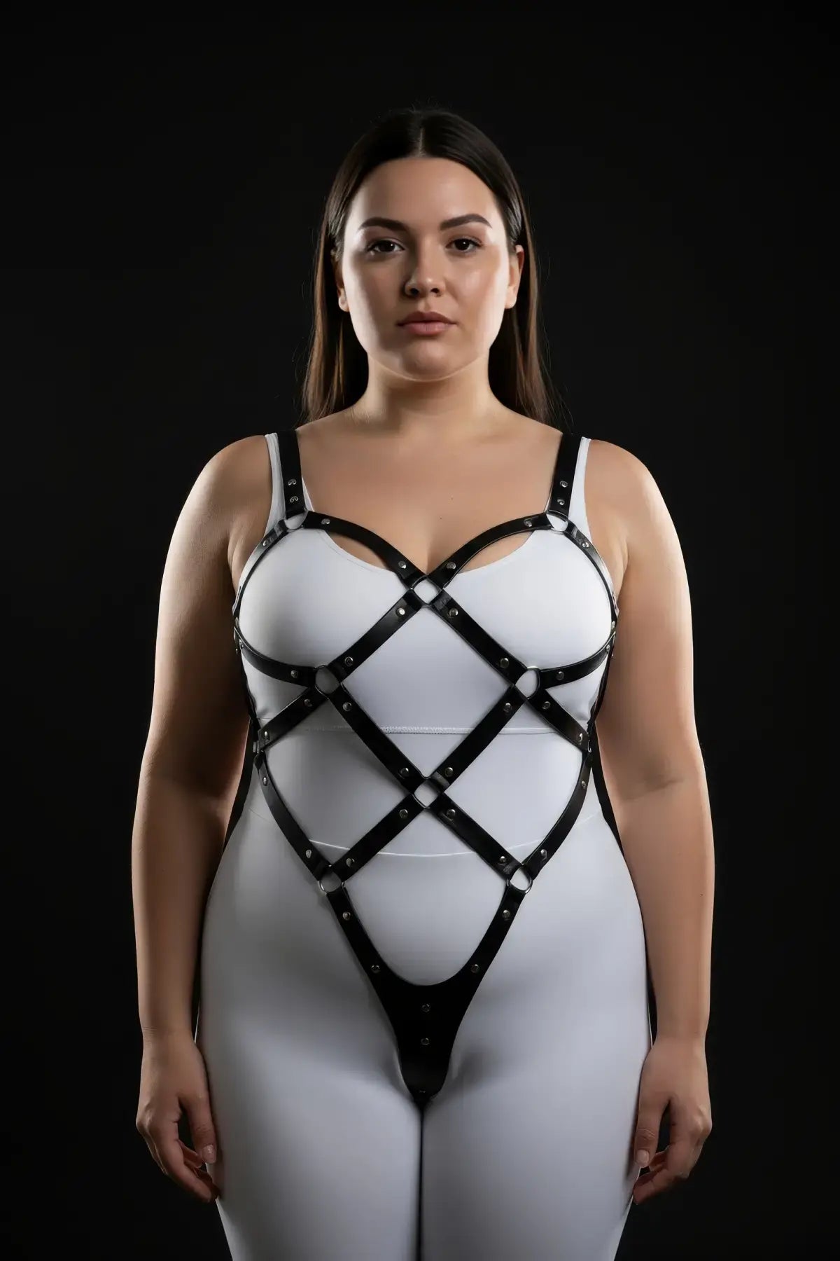 Plus size black diamond lattice body cage harness by HarnessClub in vegan leather, worn over a white bodysuit