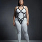 Plus size black diamond lattice torso cage harness by HarnessClub, vegan leather, worn over white bodysuit.