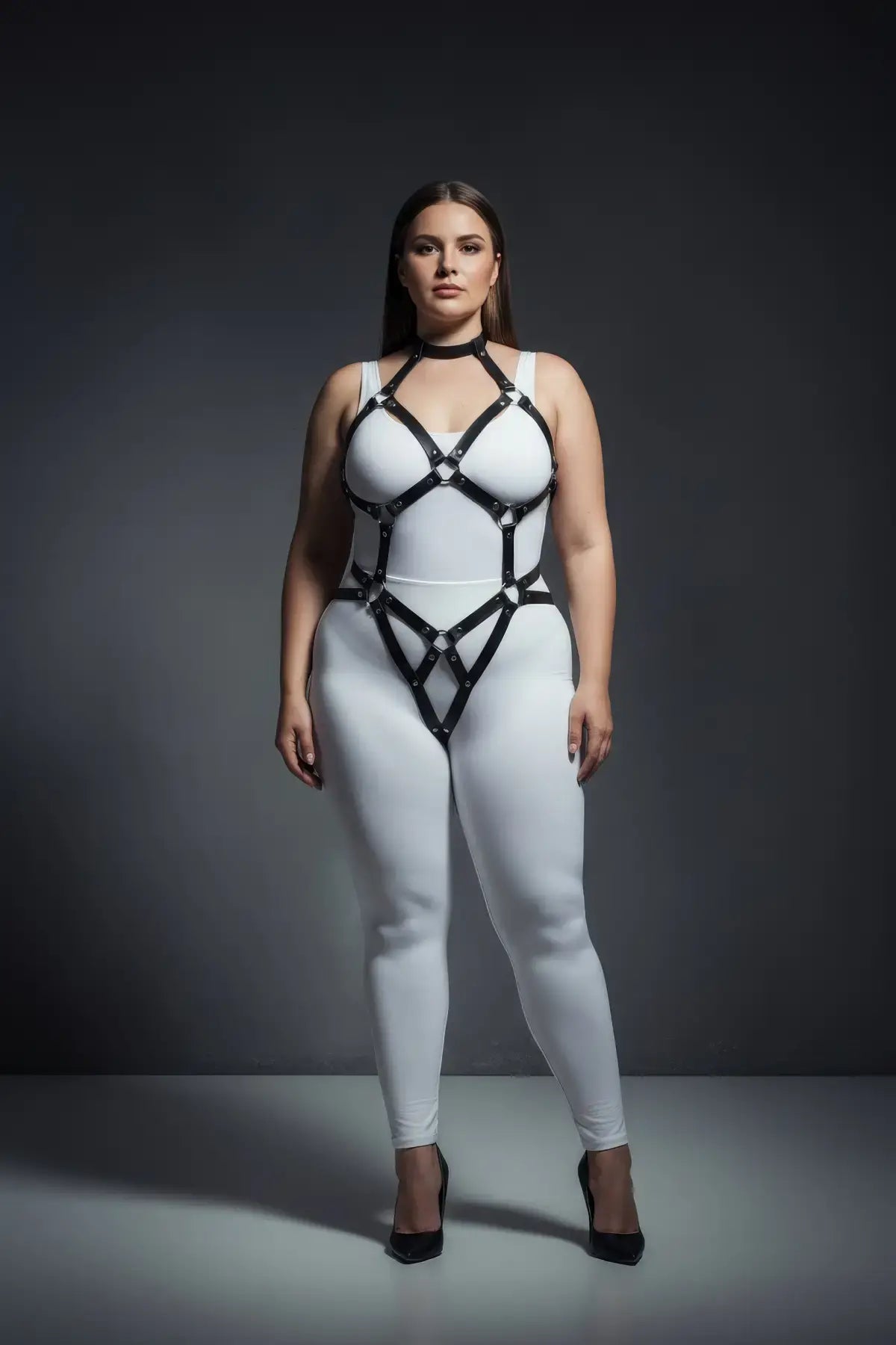 Plus size black diamond lattice torso cage harness by HarnessClub, vegan leather, worn over white bodysuit.