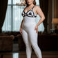 Plus-size black disc O-ring leather chest harness, vegan leather body accessory worn over a white bodysuit