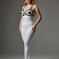 Plus size black disc O-ring vegan leather chest harness by HarnessClub over a white bodysuit